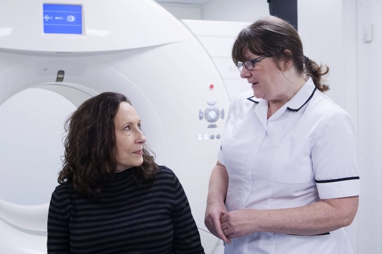 Radiographer and patient with a scanner