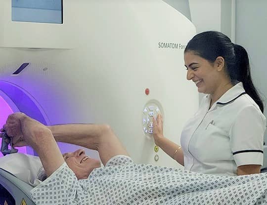 Radiographer and patient on scanner